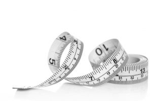 White tape measure on white background with reflection