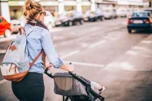 Photo of cool mom pushing a buggy on the street