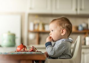 Baby eating a pomegranate fruit