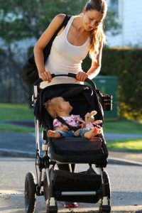 Happy woman walking with baby
