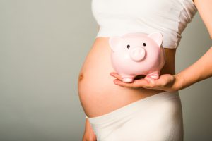 a pregnant woman touch her belly
