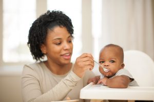 Little boy eating baby food.